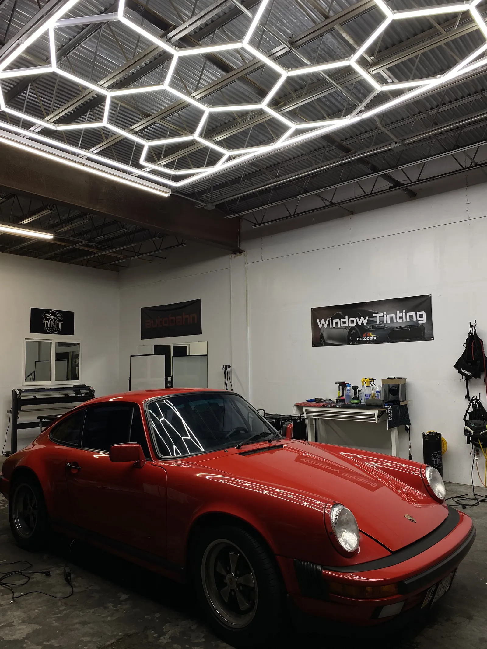 Classic red Porsche 911 getting window tint at Gulf Coast Tint Solutions shop