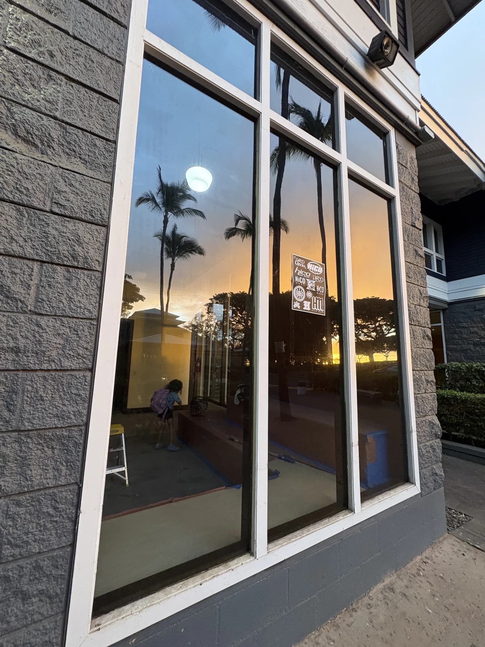 Storefront tinted windows sunset reflection