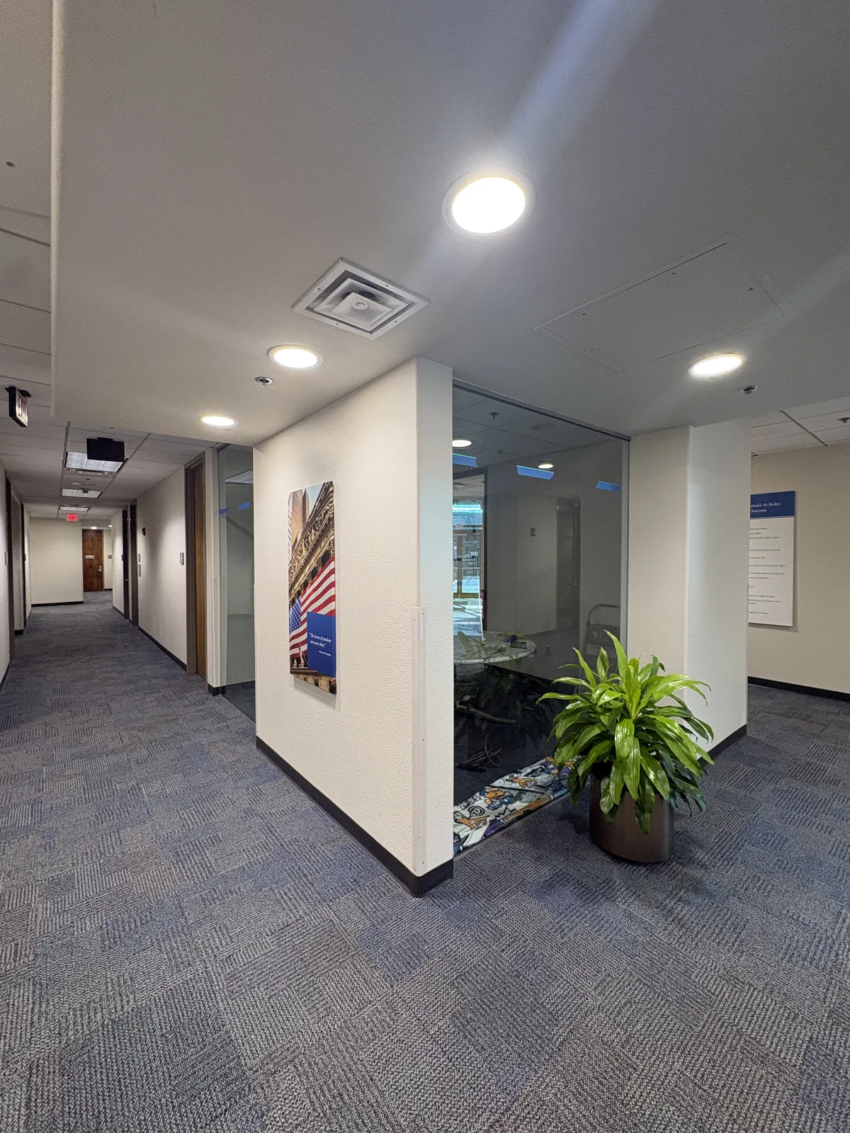 Hallway view showing dual gradient decorative film on glass conference room walls